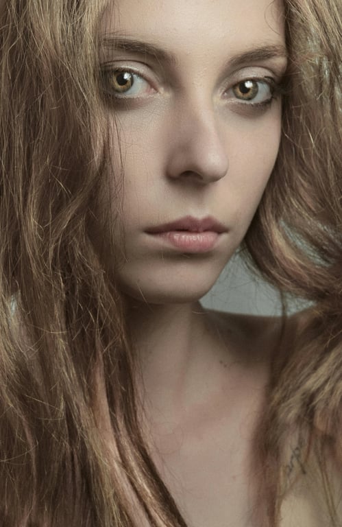 a portrait of a person edited to show silver-gray hair with metallic light response and preserved texture