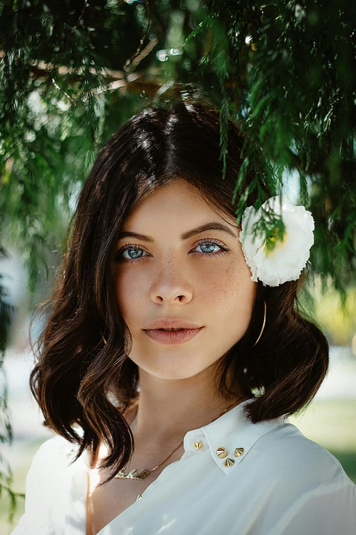 A perfectly cropped AI passport photo of a woman, meeting international size requirements, direct and neutral facial expression, uniform background color, high-resolution output.