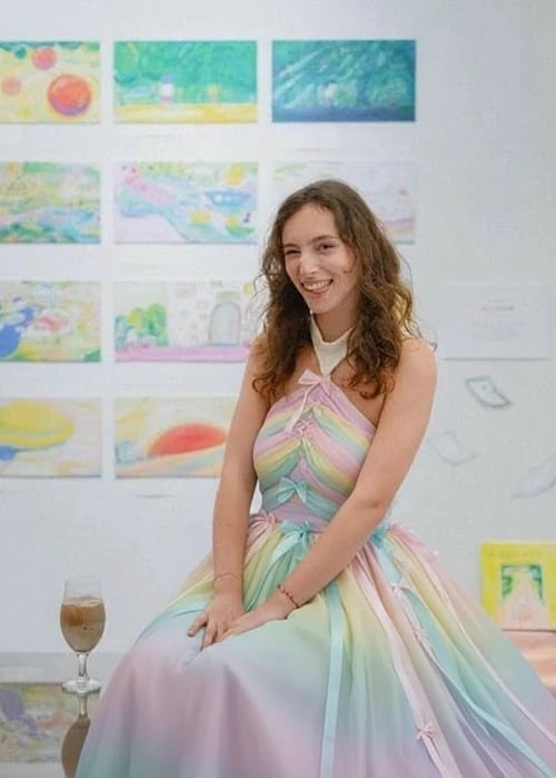 Princess dress after – person in a pastel rainbow gown with flowing ribbons