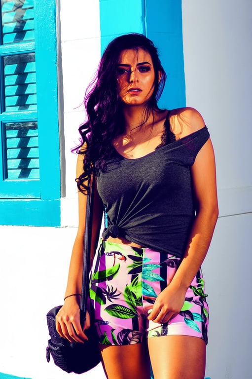 A stylized high contrast portrait of a woman, with colors pushed to extremes, clear separation between subject and background, dramatic posing, graphic art feel.