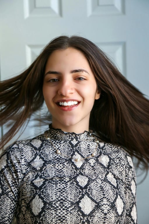 a portrait of a person edited to aggressively lower the hairline, reducing visible forehead height and increasing the impression of thick, full hair around the upper face