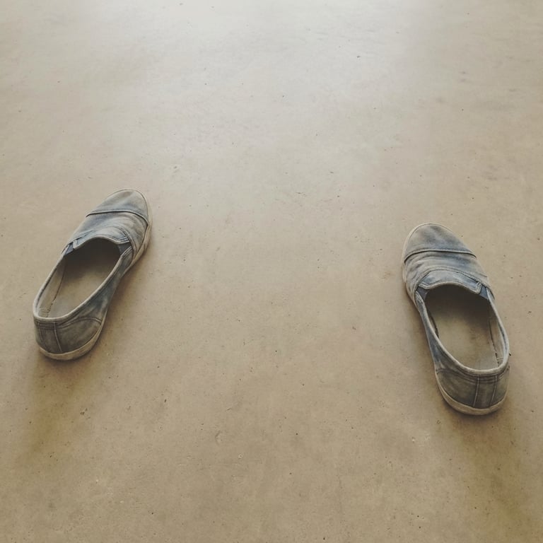 Create a close-up, brand new studio shot emphasizing the sneaker’s sheen, material details, and fine texture, with pristine reflections and a clean, minimalist white background, illuminated by soft, diffused studio lighting.