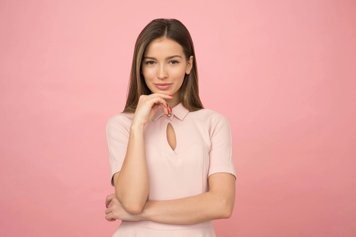 outfit generator ai before photo - woman standing against pink background