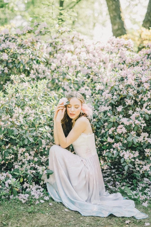 Reimagine the original person as a human character appearing alongside Hello Kitty in a 2D animated TV scene. Preserve pose and gesture, simplify the character into flat pastel animation style, and place both characters in a gentle story setting such as a kitchen, classroom, or park that matches Sanrio animation proportions.