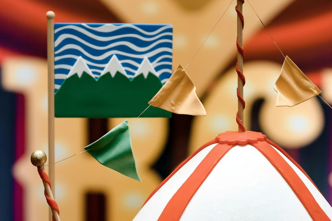 A flag for an environmental initiative: a green field with a white, stylized mountain range at the bottom and a blue wave pattern at the top, symbolizing earth and water.