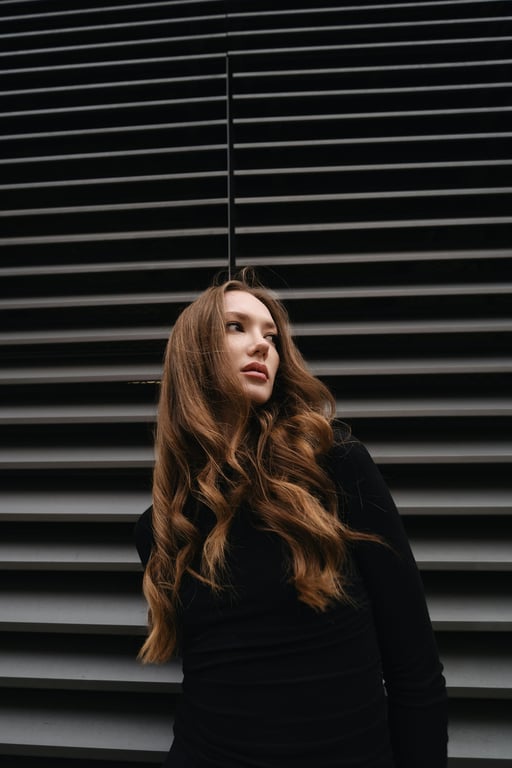 Complete the full-body view of the person by extending the image downward while keeping lighting direction, exposure, and perspective consistent from head to toe. Ensure hands, legs, and feet are anatomically correct and visually connected to the original upper body.