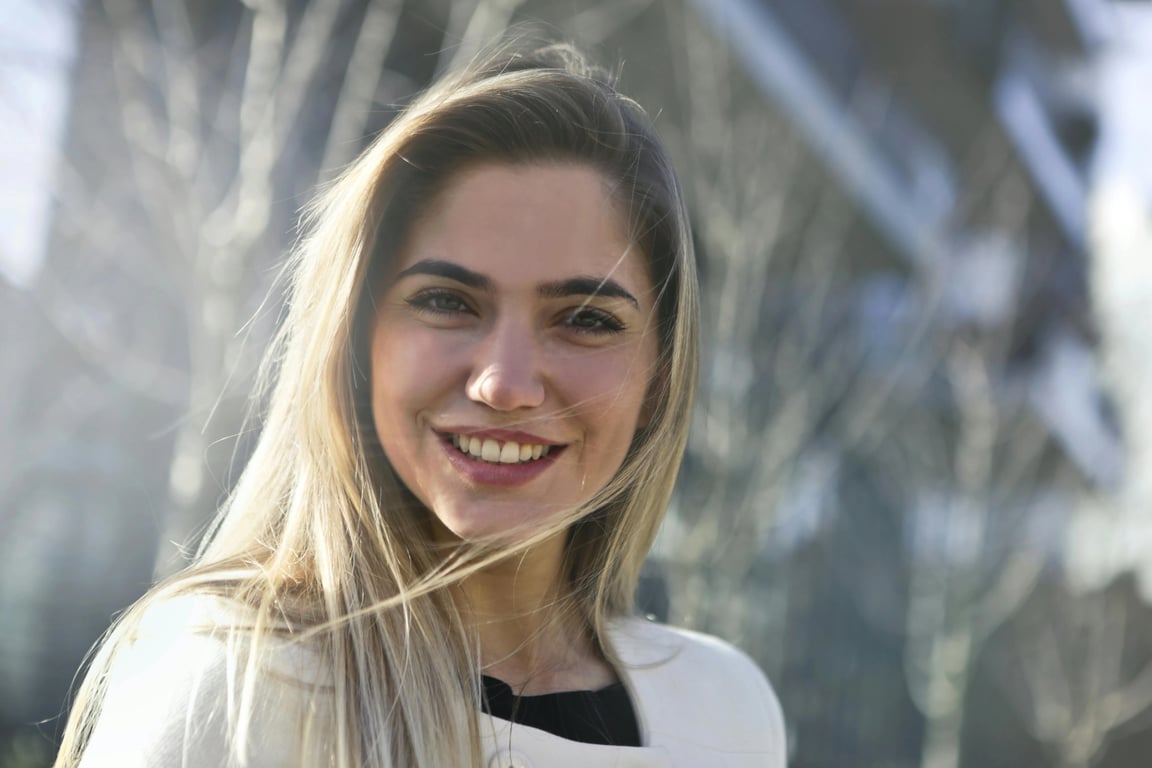 a portrait of a person styled with expressive 70s fashion elements, bold flared silhouettes, layered retro tops, visible fabric texture, confident posture, and clean lighting