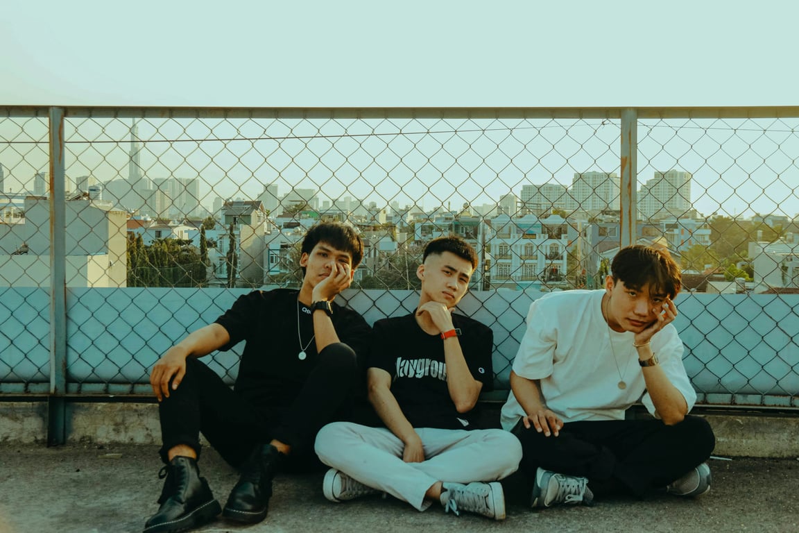 a portrait of multiple men transformed into K-pop performance outfits, including fitted stage jackets, stretch fabric tops, slim trousers designed for movement, layered outfit construction, clear seam definition, coordinated colors, confident dynamic posture, bright stage-inspired lighting, and a minimal concert-style background