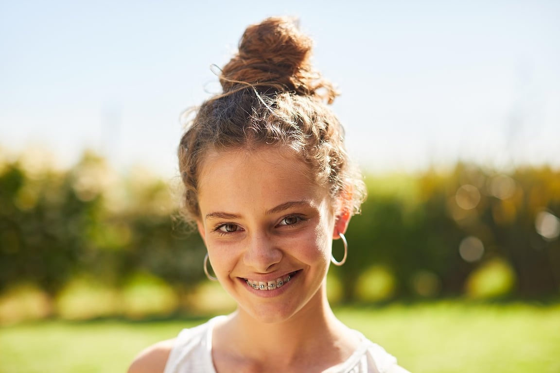 AI braces filter after transformation - outdoor photo with realistic braces look