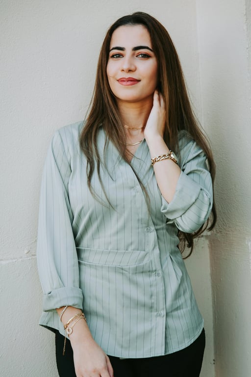 a portrait of a person edited to aggressively reshape the torso by sharply narrowing the waist and preserving full hip volume, producing a bold waist-to-hip contrast and a clearly exaggerated hourglass body shape