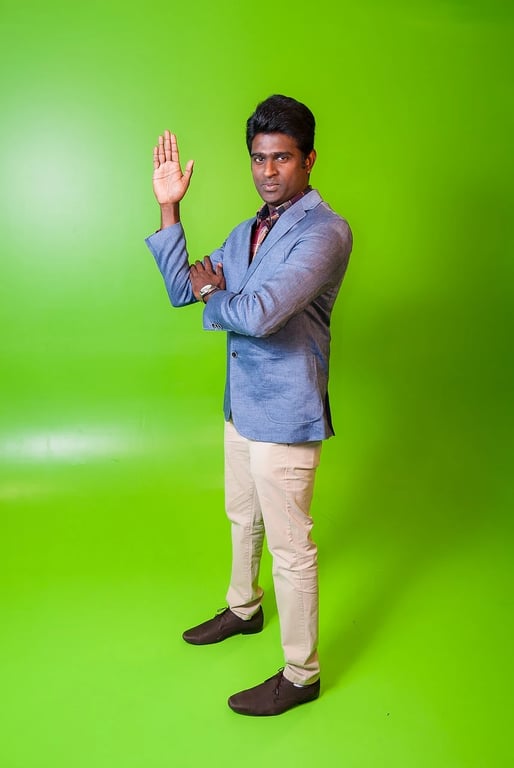 AI green screen remover before photo - man in blue shirt standing with arm raised