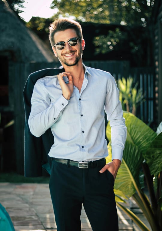 A warmly filtered environmental portrait of a man, harmony between warm subject lighting and cool background tones, balanced contrast, natural golden hour ambiance.