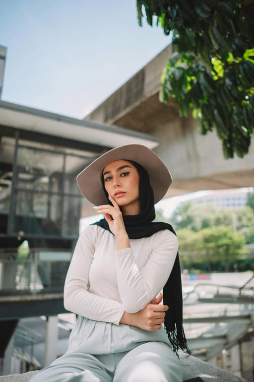 a portrait of a person styled in a fresh summer outfit look, featuring lightweight tops, breathable fabrics, relaxed-fit shorts, skirts, or trousers, bright natural colors, relaxed posture, and soft daylight lighting