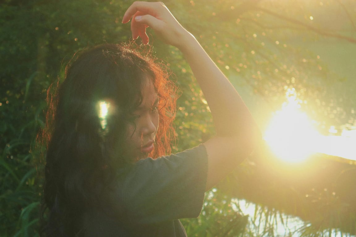 a portrait of a person with clean light balance restored by removing disordered flare and shadow artifacts, maintaining natural key light and fill light on the face, and improving overall clarity without flattening features