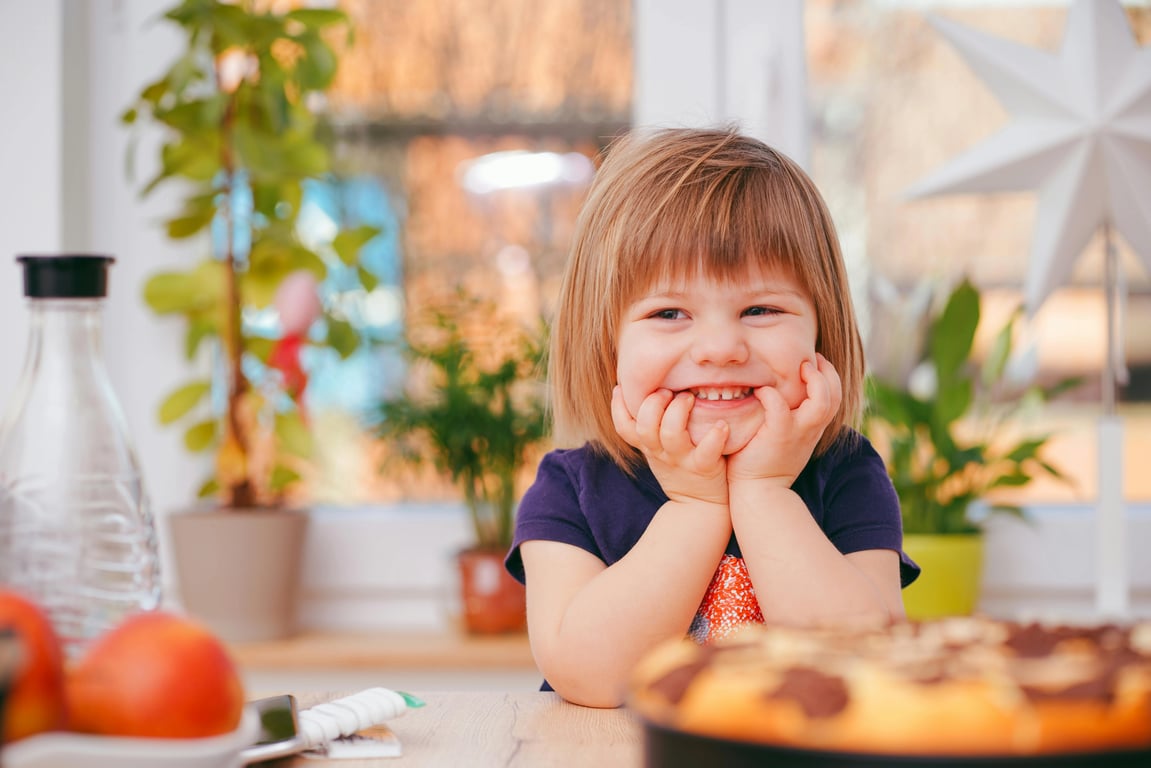 AI baby Christmas photo before photo - kid sitting at the table