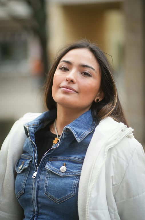 a portrait of a person with jawline definition enhanced by tightening the lower facial outline, making the jaw appear more linear and decisive; increase contrast along the jaw curve to visually narrow the lower face without actual slimming; preserve jaw width, chin length, and identity; maintain skin pores and color accuracy; avoid cut lines or blur tricks; do not alter the background; the improvement must be clearly visible