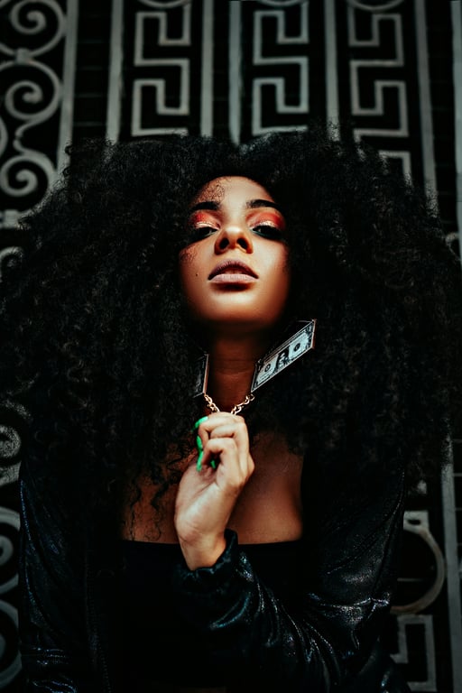 A close-up portrait of a woman converted into monochrome ASCII art, using a dense mix of characters (like @, #, %, *, `, .) to create gradients and facial details.