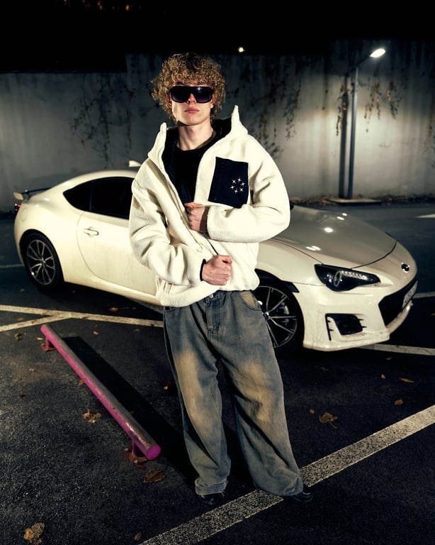 a portrait of a man edited in a Korean medium-length men hairstyle style, so that the hair is straight and medium length all around the head, slightly covering the forehead and ears in a common Korean men haircut silhouette, with no sharp length contrast, no curls or waves, and unchanged face and original lighting