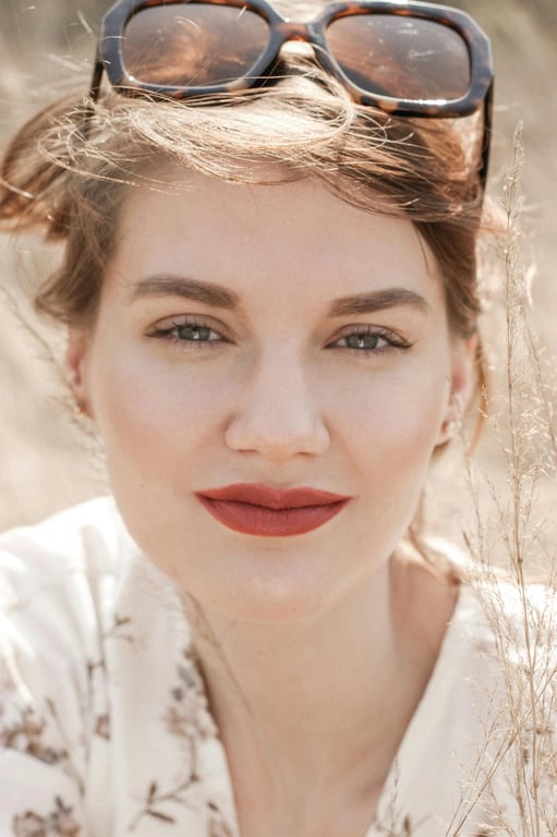 a portrait of a person edited to create a model-style face shape by strongly narrowing facial width, reducing jaw and cheek mass, forming a tall narrow face silhouette, with a dramatic and clearly noticeable transformation