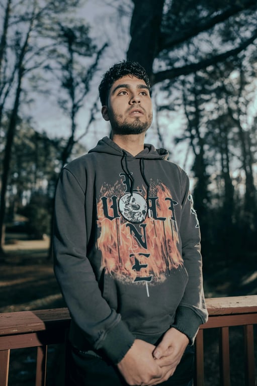 a portrait of a person illustrated in a Marvel Rivals–inspired hero game style with semi-realistic anatomy, smooth stylized skin, strong facial definition, cinematic game lighting, vibrant color grading, and a polished competitive hero shooter appearance