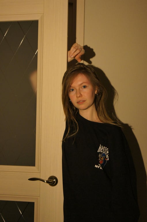 a portrait of a person transformed into a SpongeBob SquarePants cartoon style, using thick rounded dark outlines, flat bright pastel colors dominated by sponge yellow and ocean blue, simplified facial features, cheerful exaggerated expression, minimal shading, and a clear 2D Nickelodeon animation look.