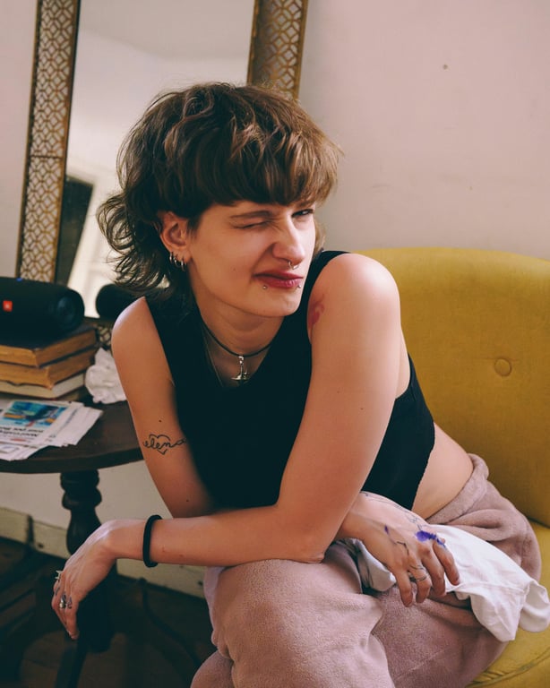 anime tattoo before photo - woman sitting on the sofa