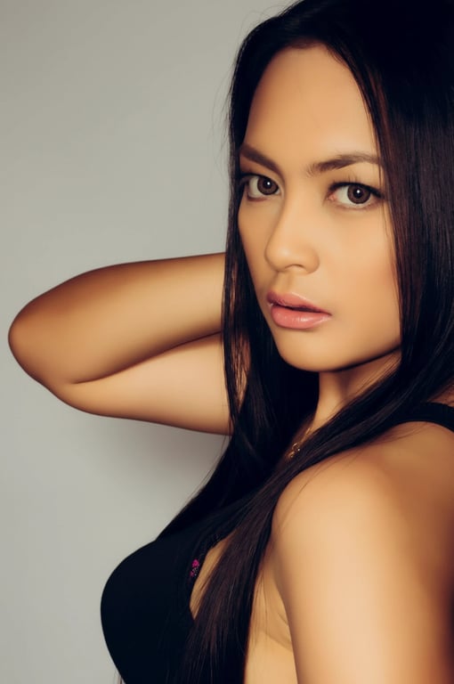 a portrait of a woman with the background changed to a solid light gray studio backdrop, creating a professional and minimalist aesthetic