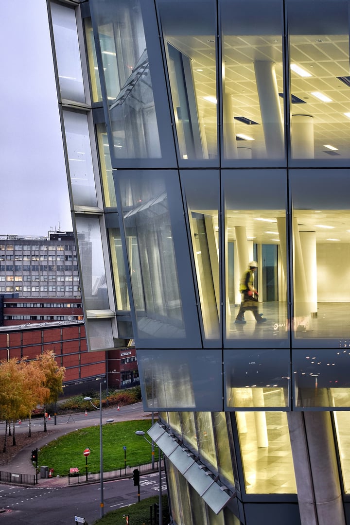 Construction worker inside big building | Bellcom