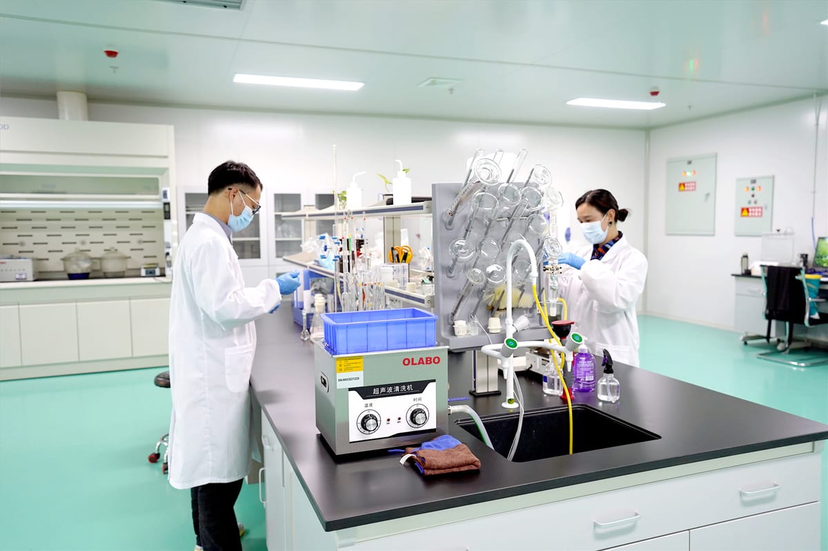 Technicians testing materials in a clean laboratory