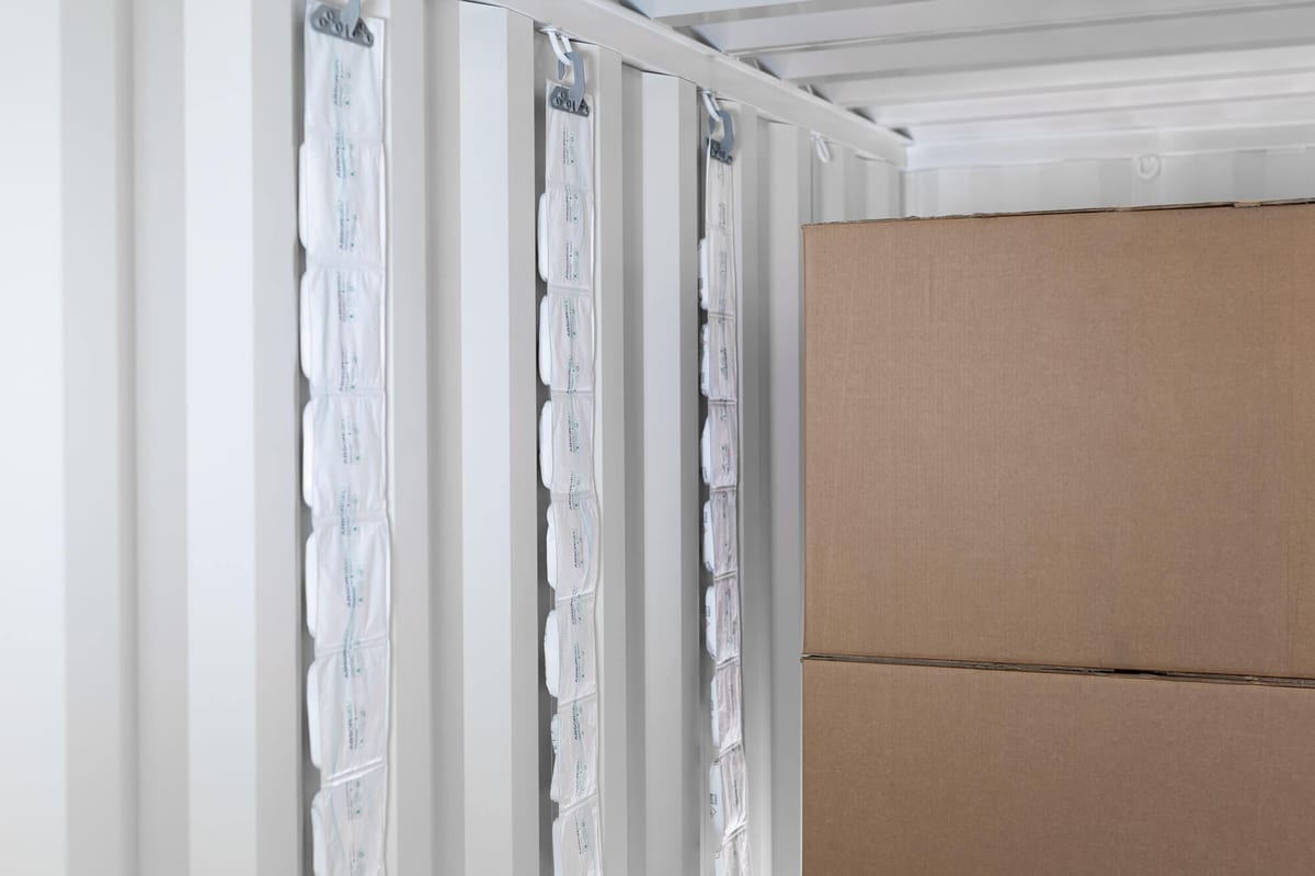 Container desiccant strips hanging inside a shipping container