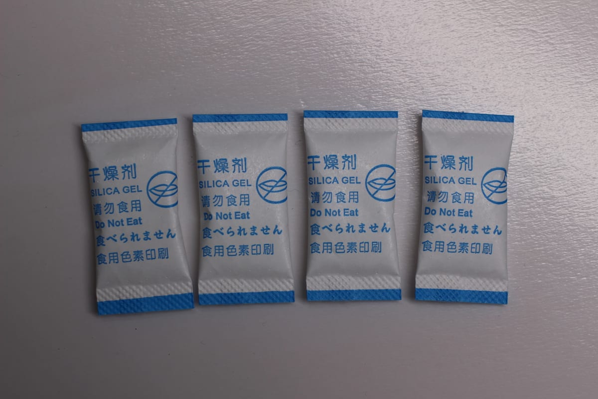Finished silica gel desiccant sachets with printed warning text