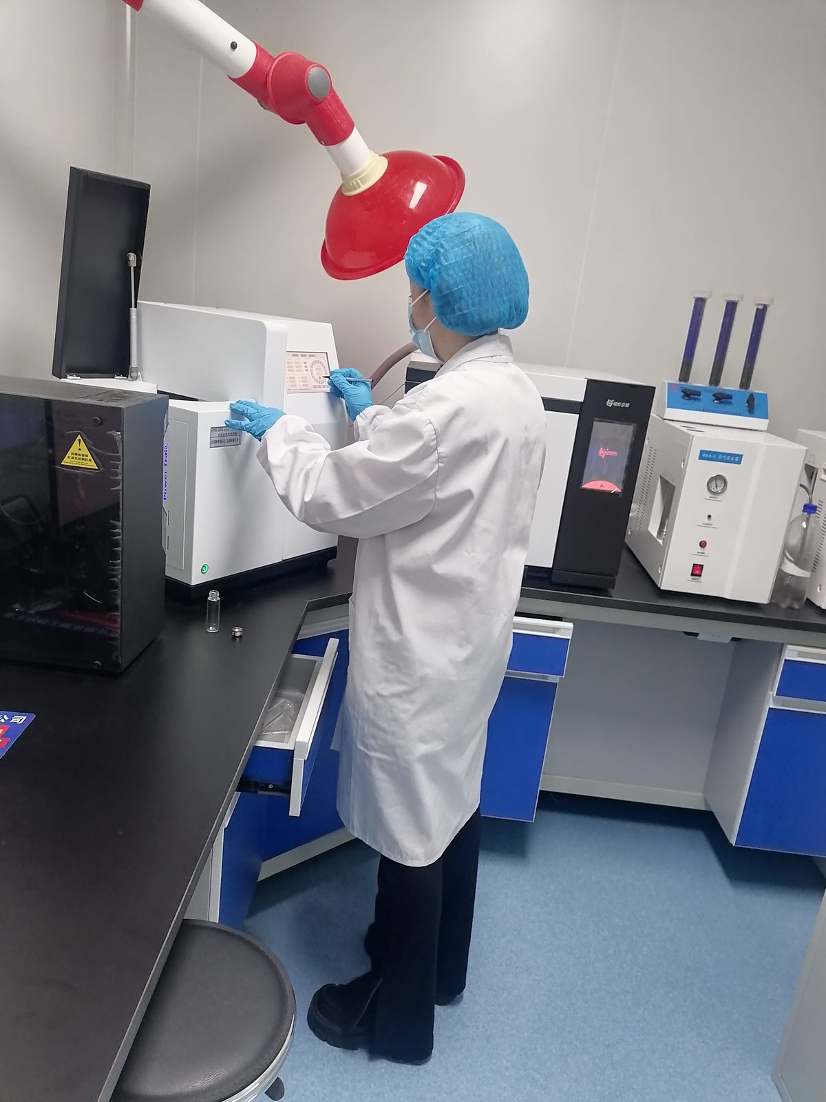 Technician operating laboratory testing equipment