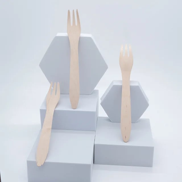 Wood forks displayed against a clean studio backdrop