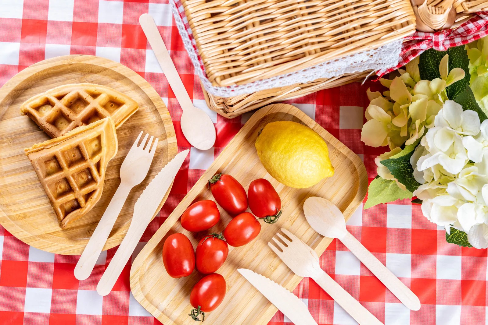Wood cutlery arranged with food for an outdoor-style meal