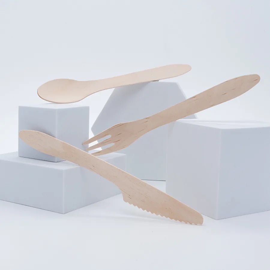 Wood knife, fork, and spoon presented on a clean studio display
