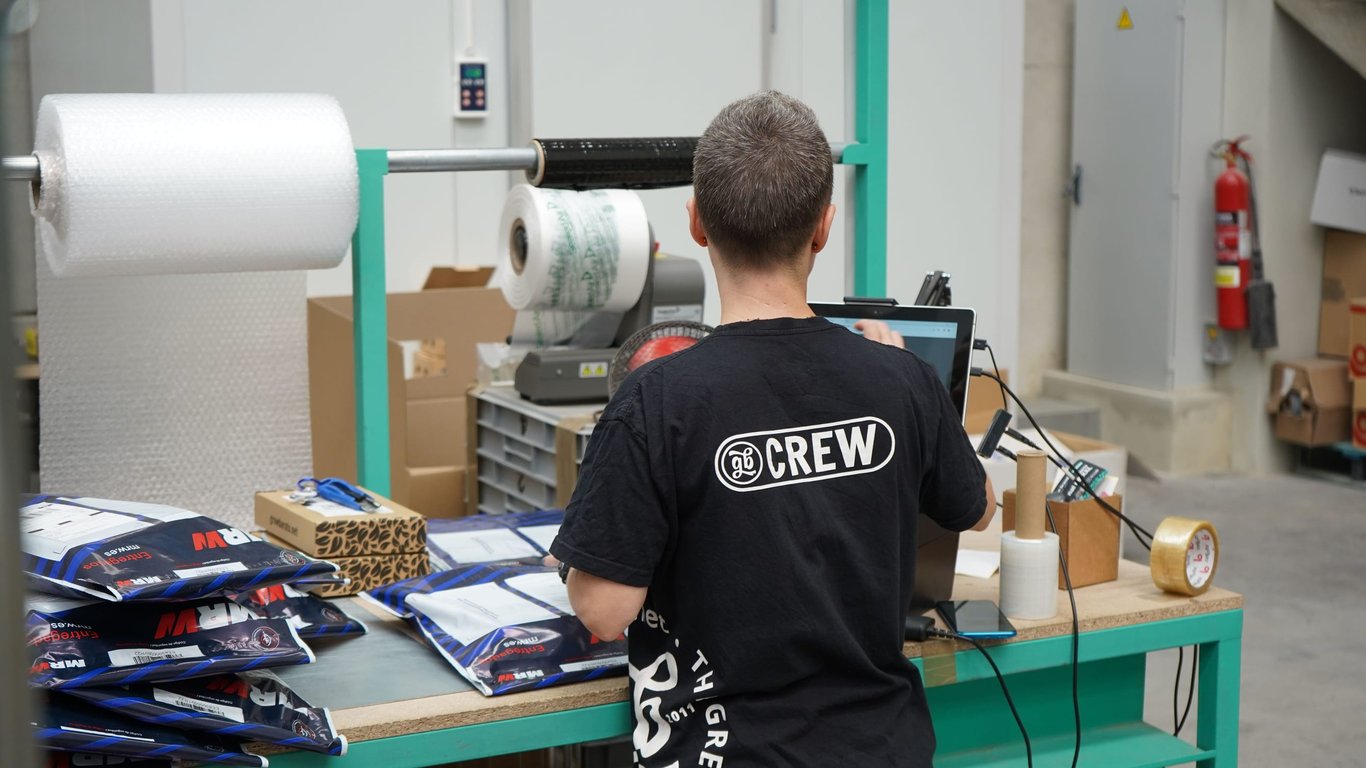 Warehouse worker preparing shipping paperwork for an outbound order