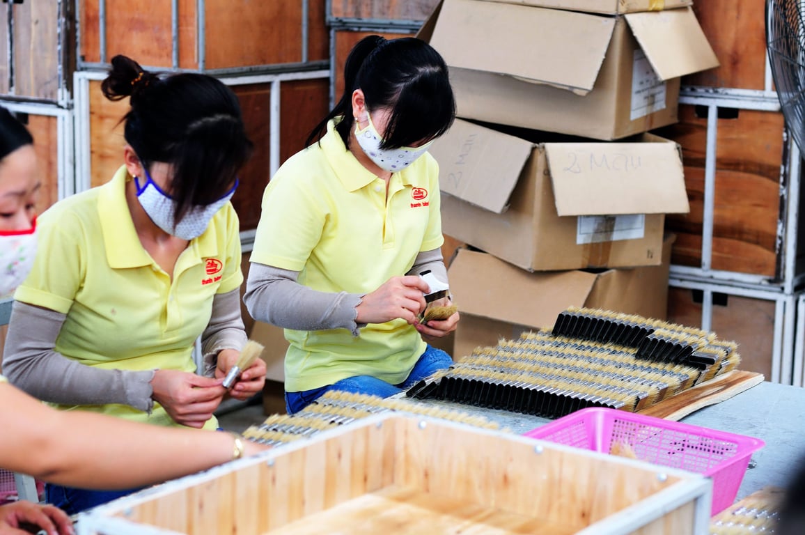 Factory workers packing product for a private label order