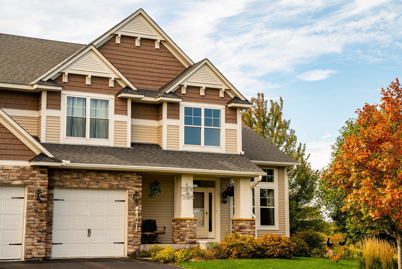 Cedar-shake gable accents over lap siding with white trim on a craftsman-style home