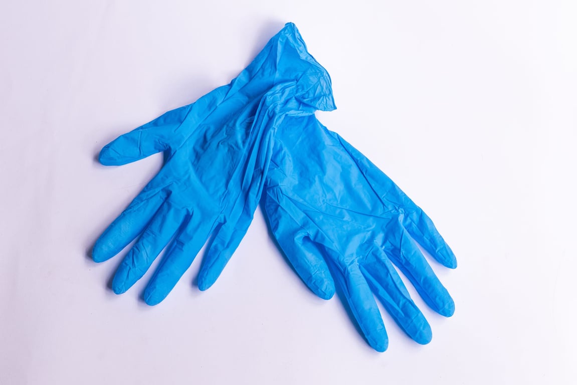 A pair of blue disposable gloves
