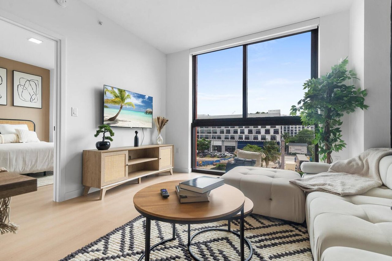 Bright furnished living room with city views in a Wynwood, Miami apartment