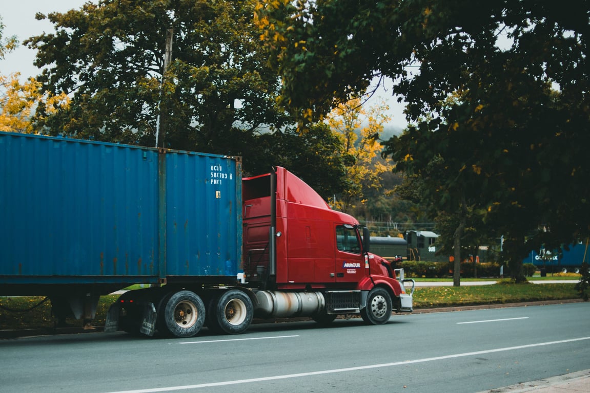 Truck hauling a shipping container on a chassis