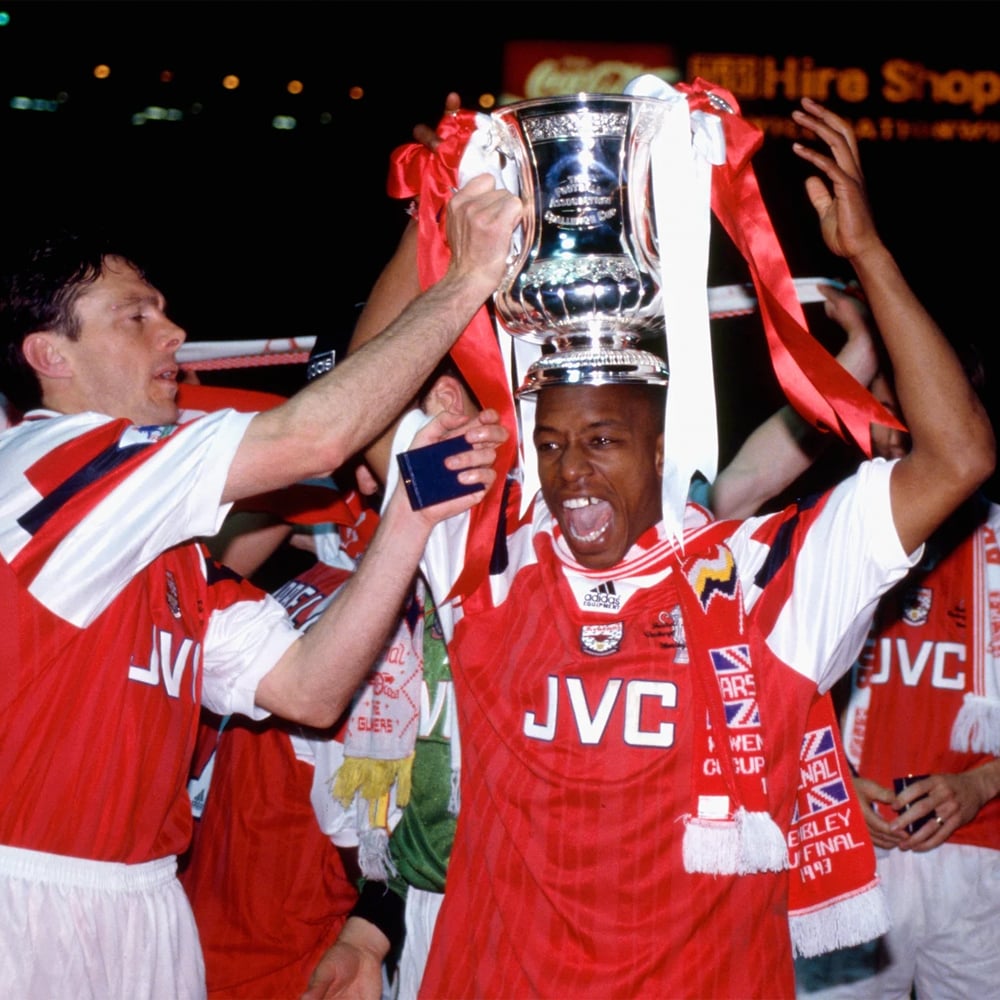 Classic Arsenal team celebrating with a trophy