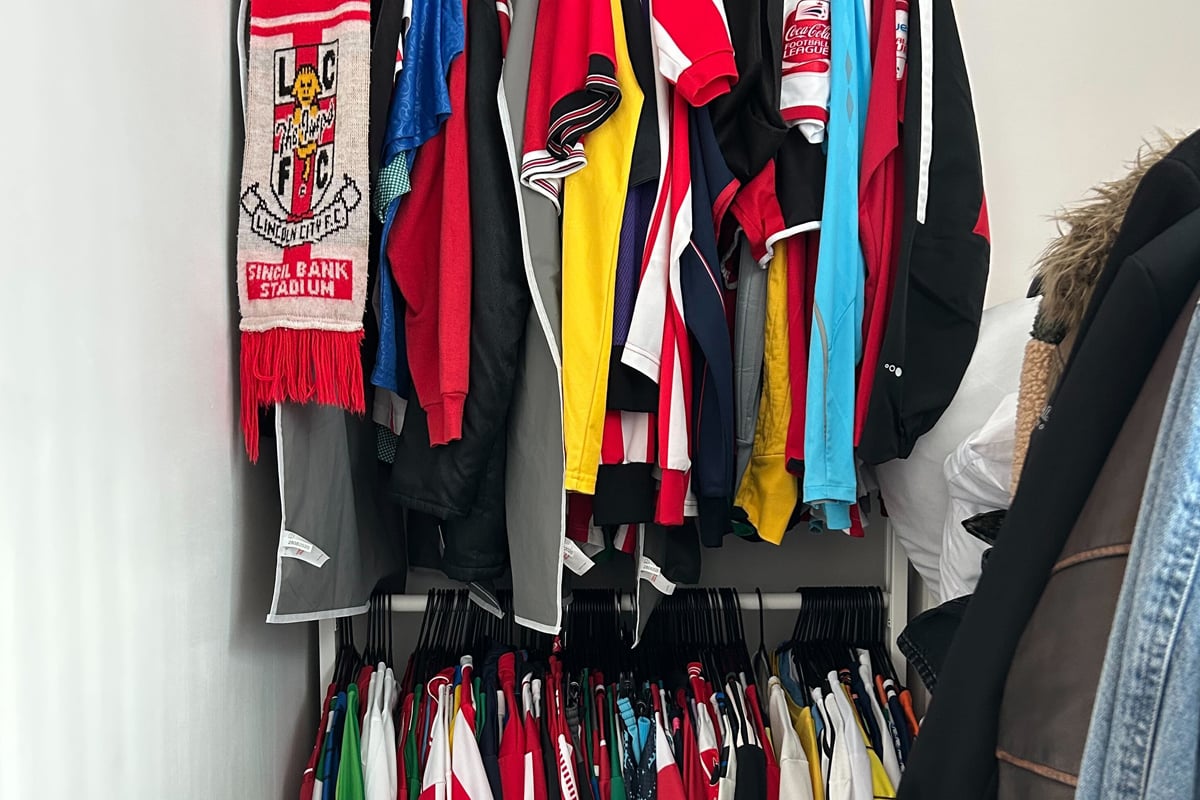 Wide shot of Tom's shirts on rack