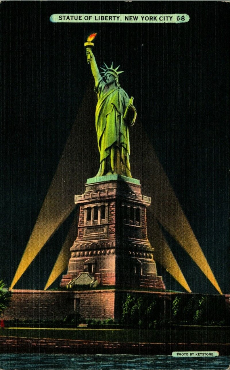 Statue of Liberty at night with four spotlights