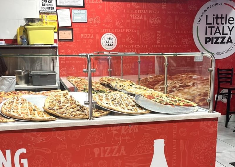 Pizza behind glass at Little Italy Pizza