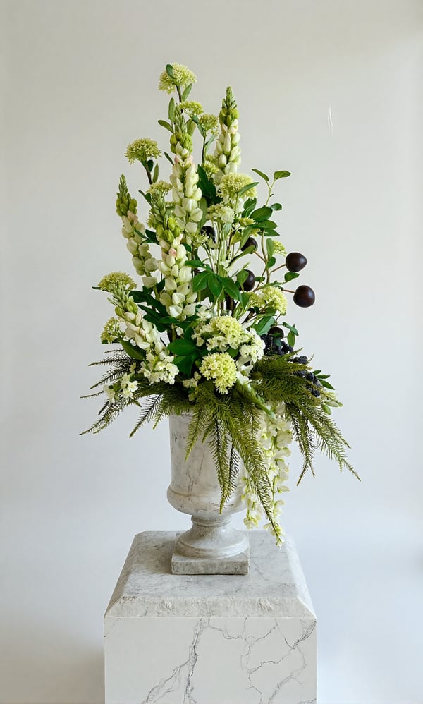 Luxury green and white faux floral arrangement with plum fruit branches in a tall white stone urn, 100cm.