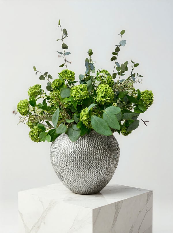 Green viburnum in a large grey stone vase