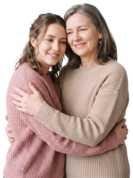 MOTHER AND DAUGHTER EMBRACE WARMAMENTE AGAINST A LIGHT BACKGROUND