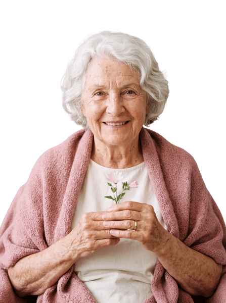 ELDERLY WOMAN SMILING WHILE HOLDING DELICATE PINK FLOWERS