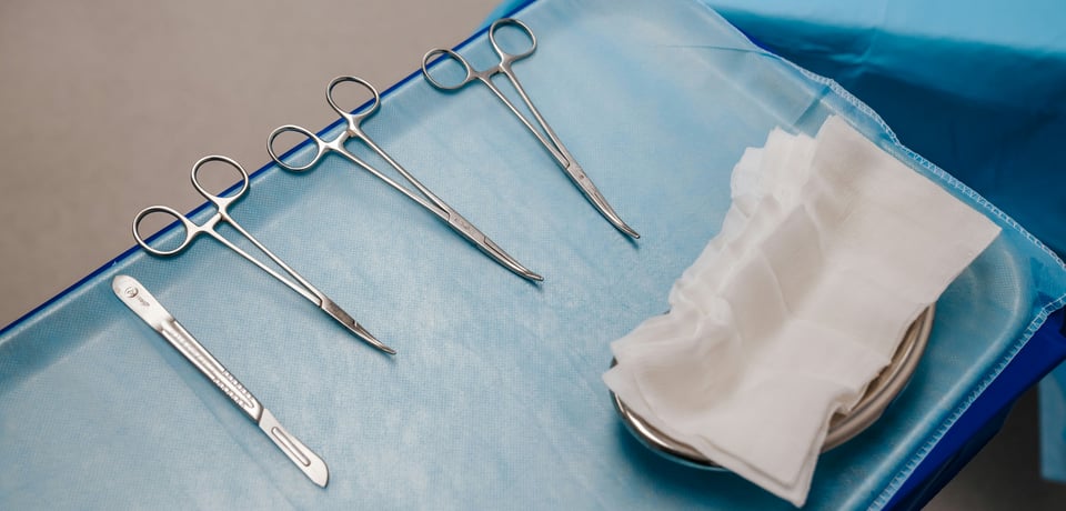 A tray with surgical instruments arranged for sterilization